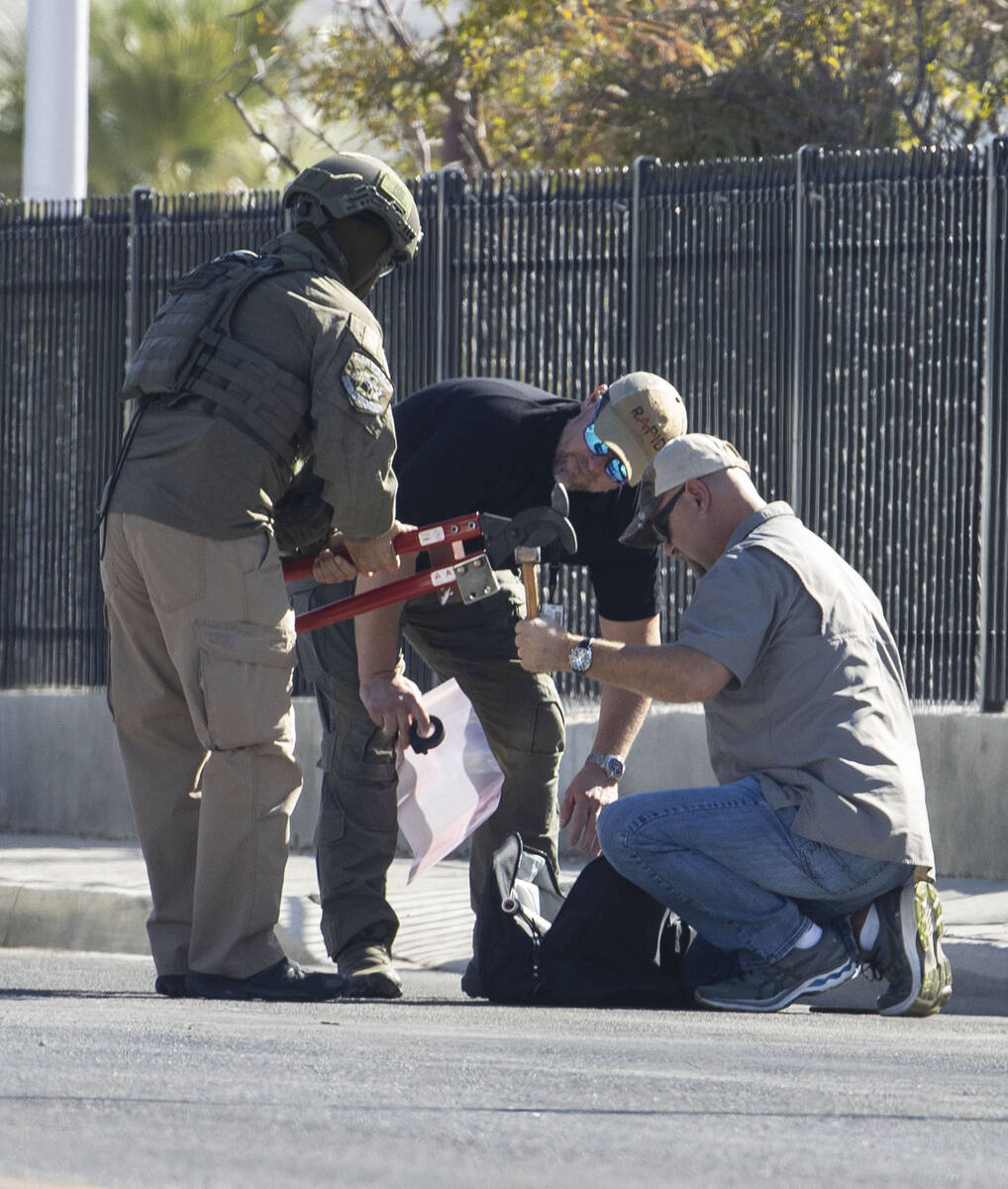 The Las Vegas Fire Department bomb squad officers prepare to investigate a suspicious device in ...