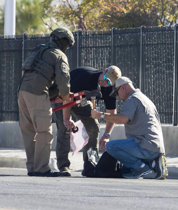 The Las Vegas Fire Department bomb squad officers prepare to investigate a suspicious device in ...