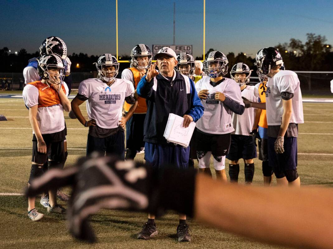 The Meadows High School defensive coordinator Rodney Vollan directs his players during practice ...
