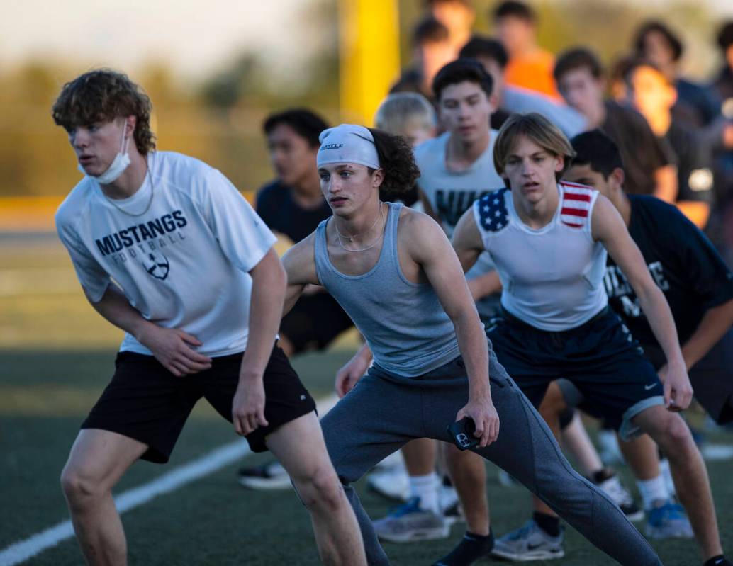 The Meadows High School football players, including Tanner Woods, front, Gage Rinetti, and Finn ...