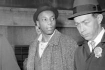 Norman 3X Butle,, a suspect in the slaying of Malcolm X, is escorted by detectives at police he ...