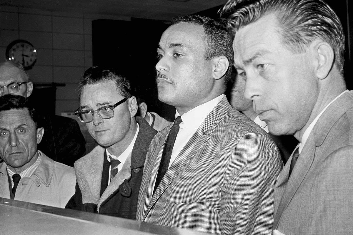 Thomas 15X Johnson, center, is booked as the third suspect in the slaying of Malcolm X, in New ...