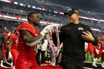 UNLV Rebels running back Charles Williams (8) presents Hawaiian Leis to head coach Marcus Arroy ...
