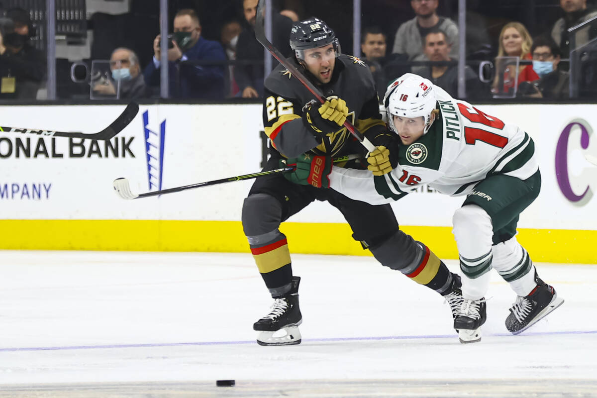 Golden Knights center Michael Amadio (22) and Minnesota Wild center Rem Pitlick (16) battle for ...