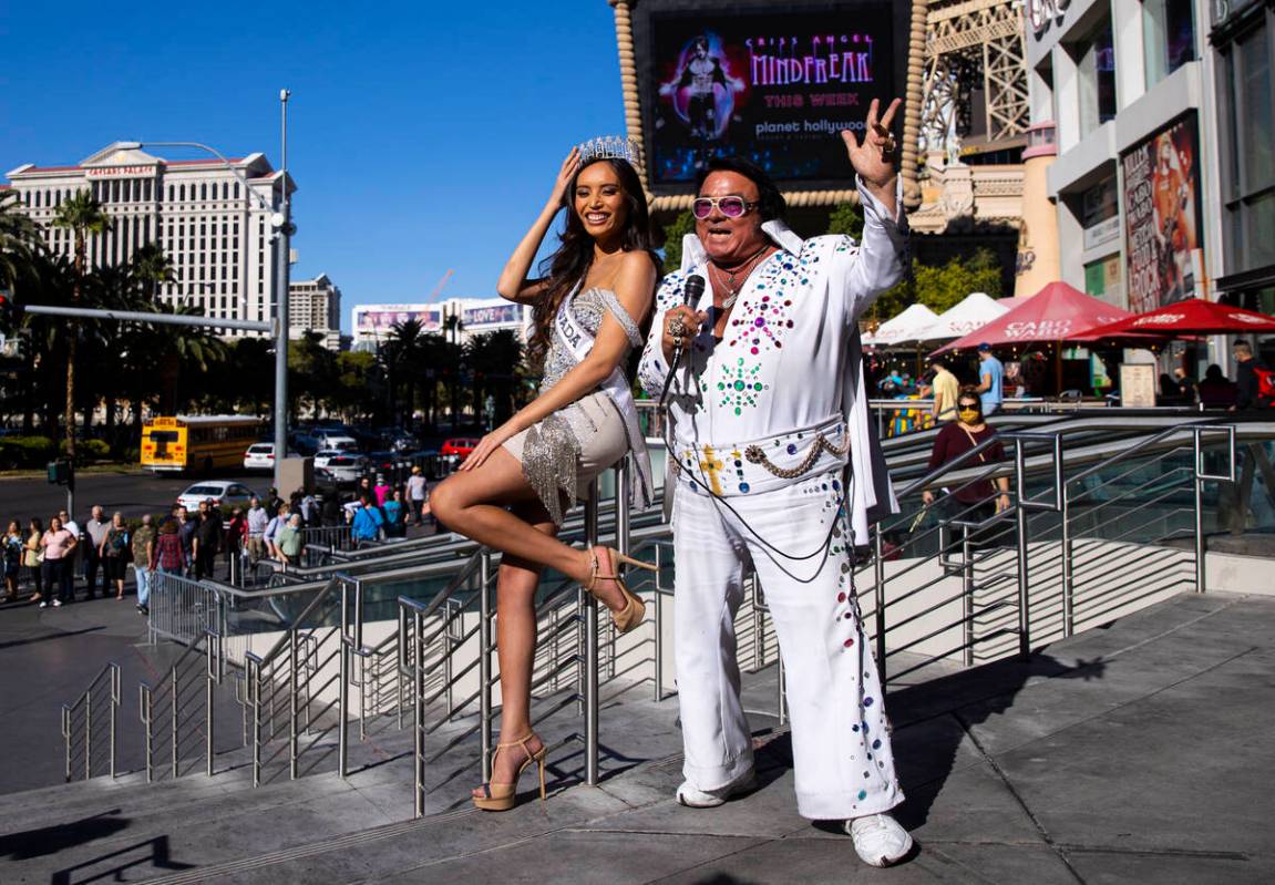 Miss Nevada USA Kataluna Enriquez, left, poses for a picture with Elvis impersonator Michael Ro ...