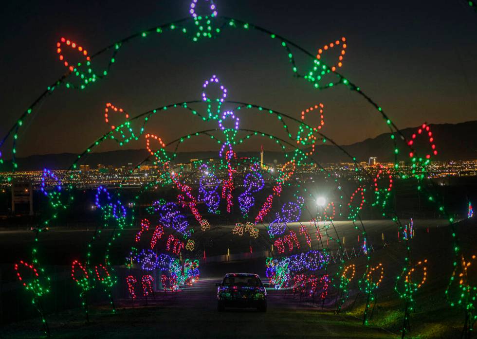 Cars ride through twinkling lights at the Las Vegas Motor Speedway in Las Vegas on Monday, November 30, ...