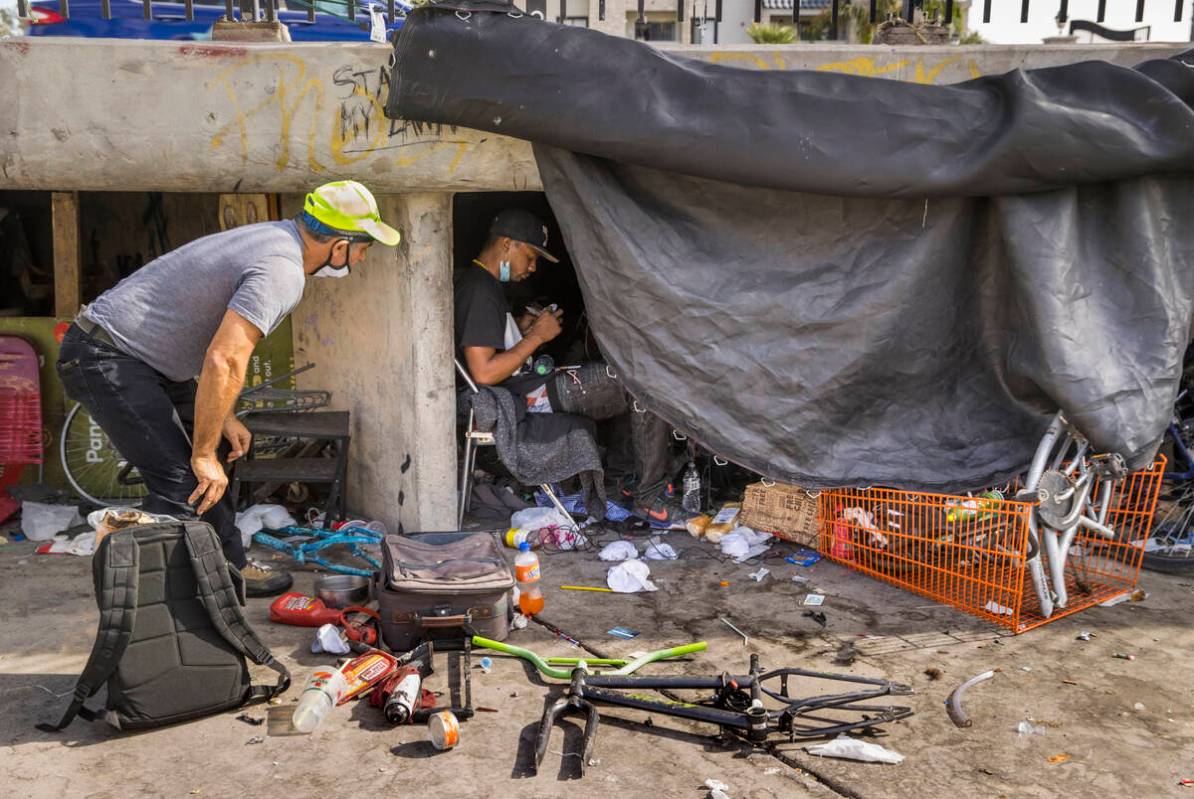CrossRoads CEO Dave Marlon, left, offers food, drink and medical resources to the homeless in O ...