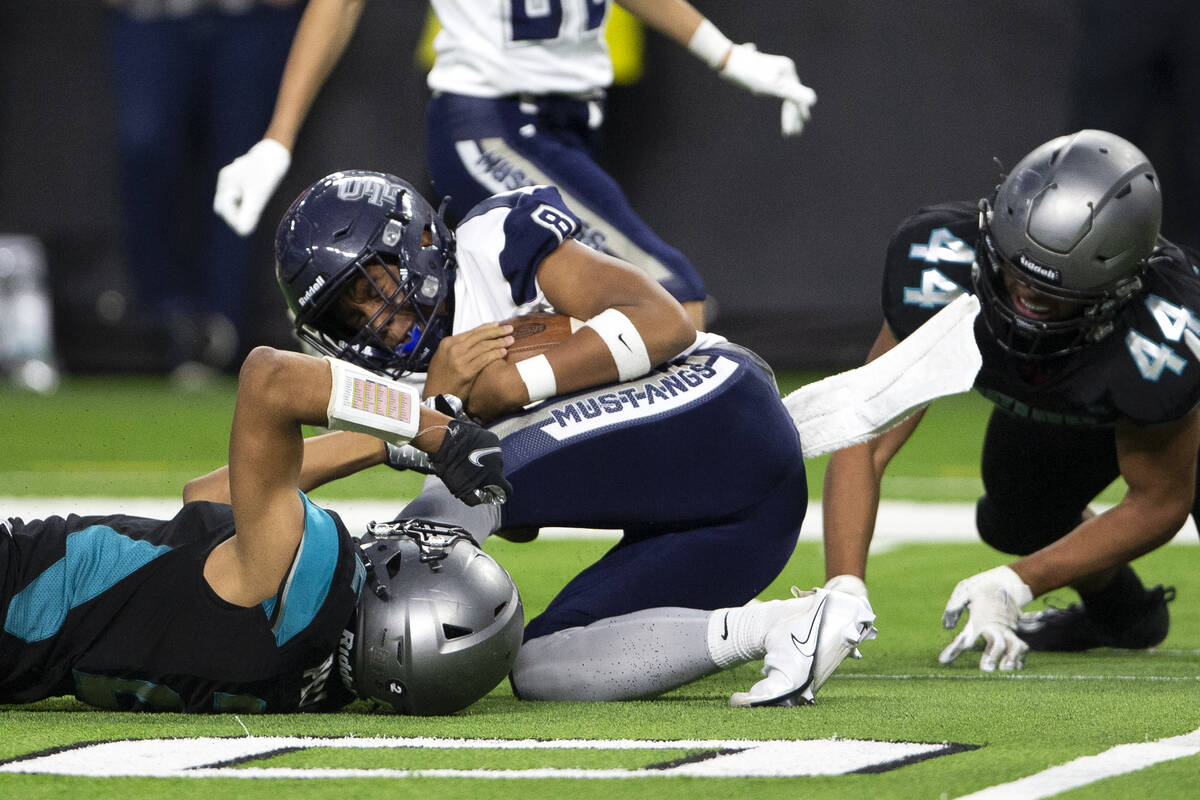 Shadow Ridge quarterback Coen Nicholas Coloma (8) is brought down by Silverado fast safety Dona ...