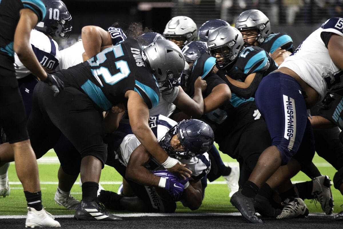 Shadow Ridge running back Jaquieze Holland (25) scores a touchdown as Silverado defenders attem ...