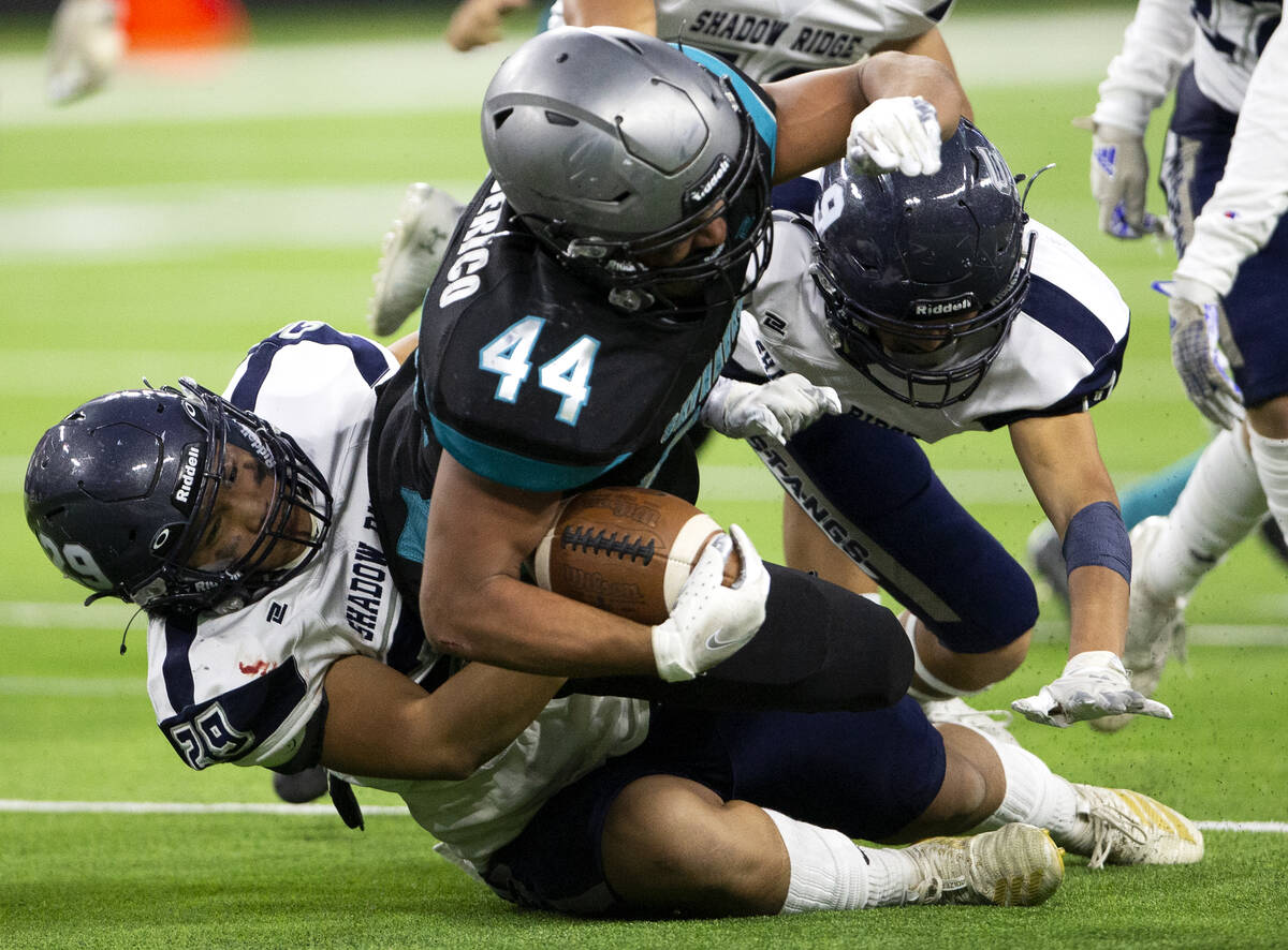 Silverado offensive linebacker Chris Federico (44) is tackled by Shadow Ridge defensive back Ga ...