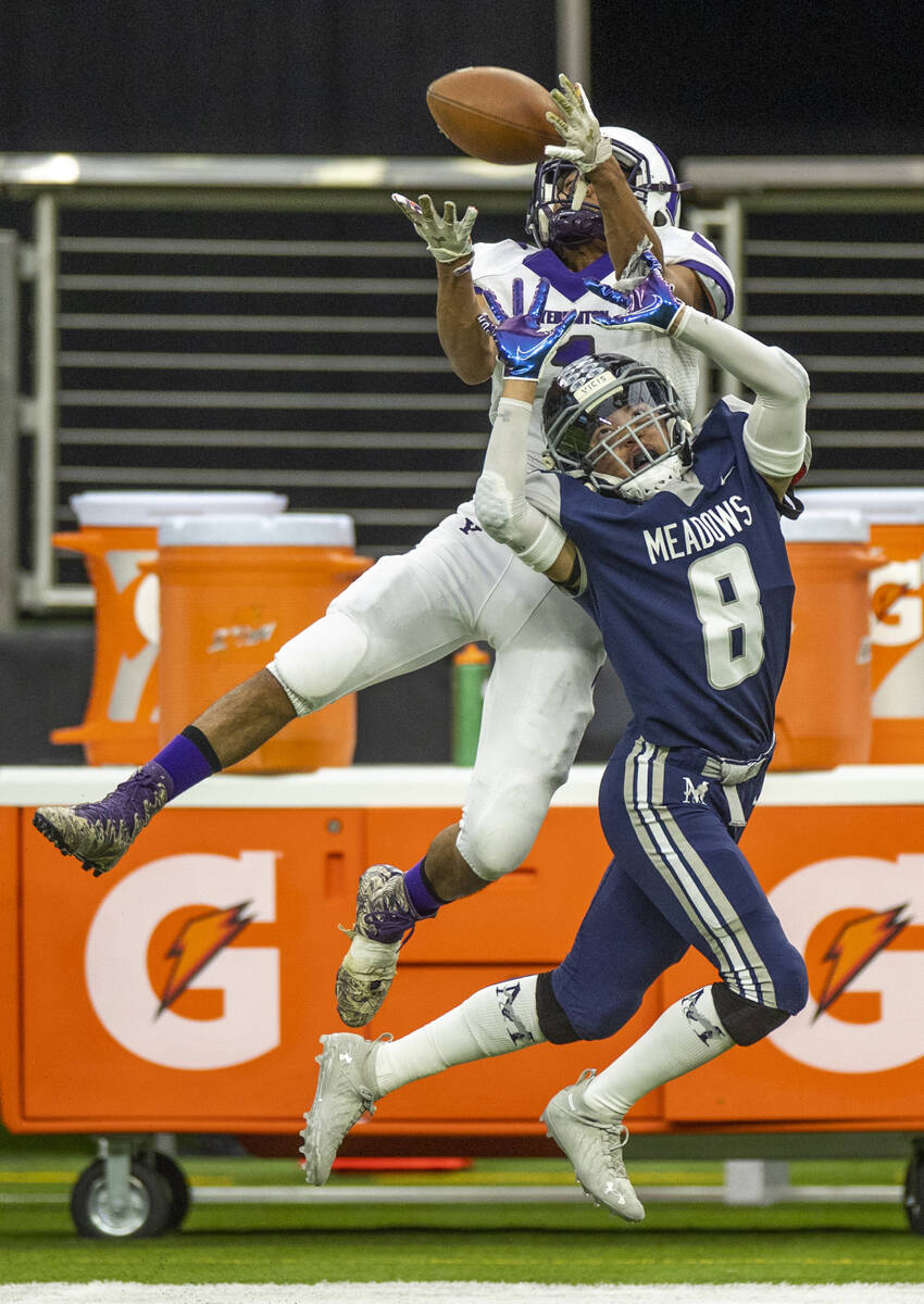 Yerington receiver Donovan Martinez (1) goes up high for a pass attempt over The Meadows defens ...
