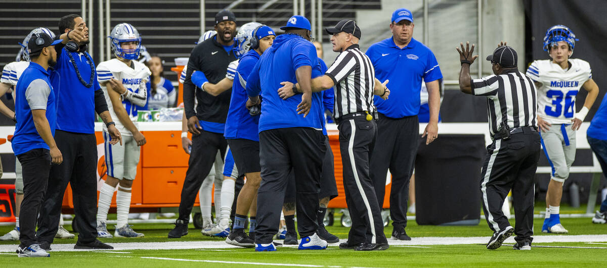 Officials calm down McQueen coaches after words were exchanged with Bishop Gorman during the fi ...