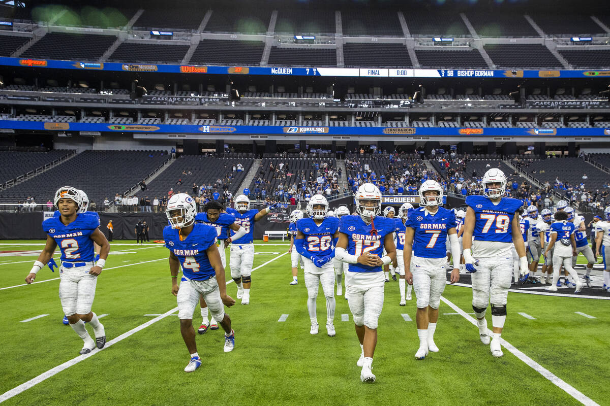 Bishop Gorman players walk off the field after defeating McQueen 56-7 following their Class 5A ...