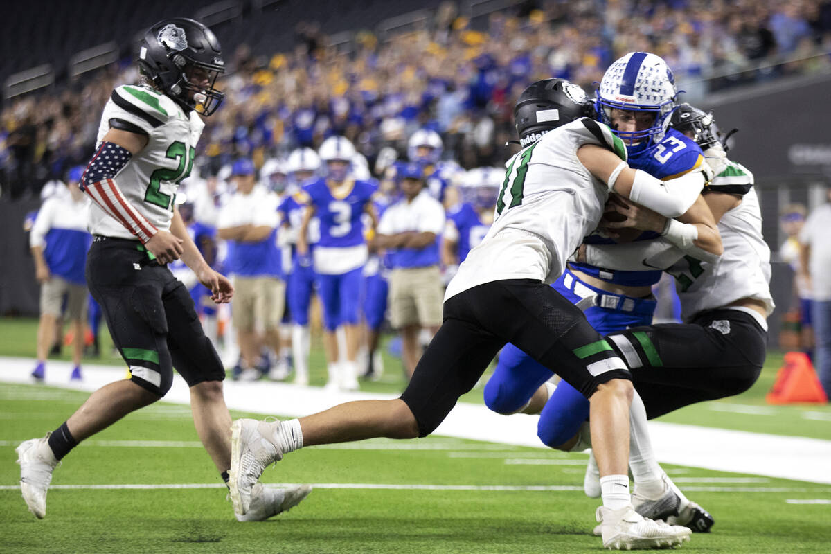 Moapa Valley running back Landon Wrzesinski (23) is tackled just before the endzone by Virgin V ...