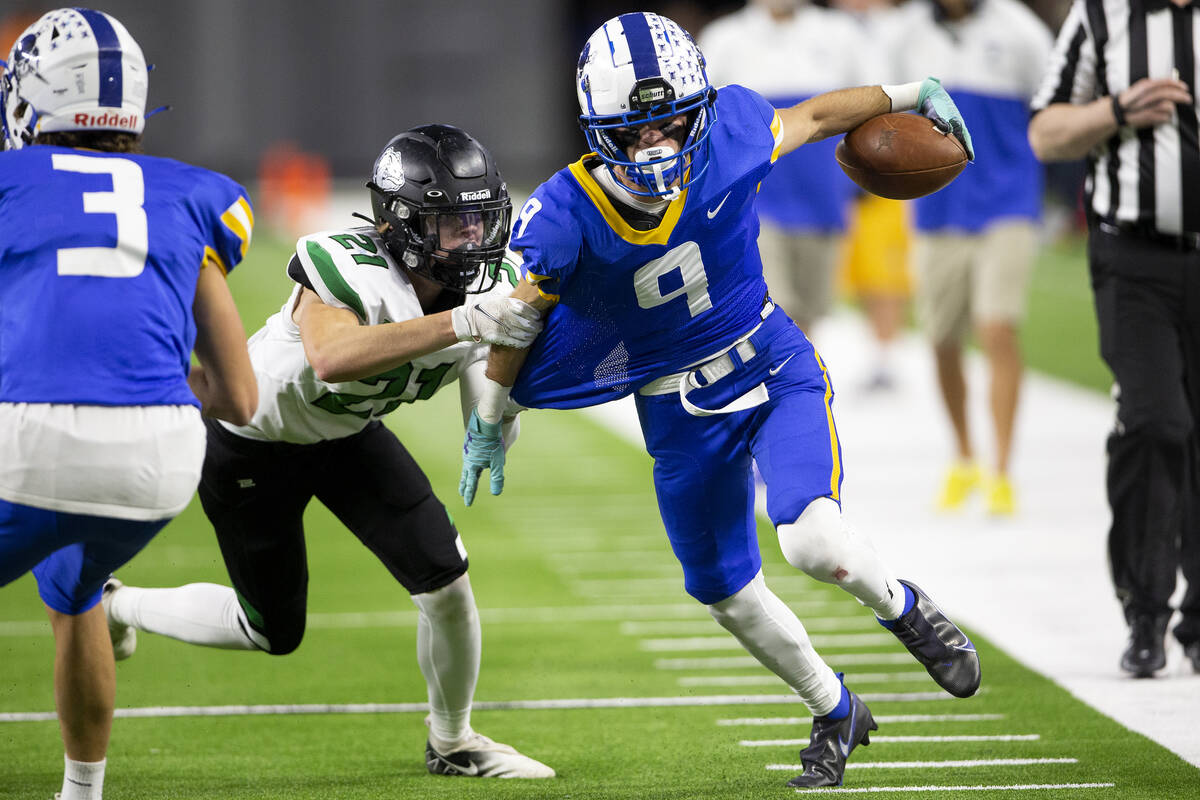 Virgin Valley strong safety Jared Jensen (21) attempts to tackle Moapa Valley wide receiver Aus ...