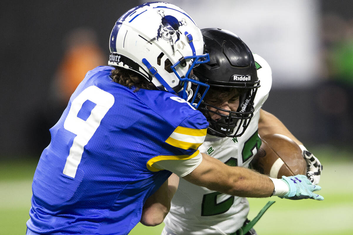 Virgin Valley wide receiver Benson Leavitt (23) pushes through an attempted tackle by Moapa Val ...