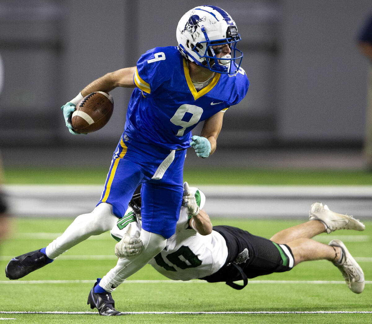 Virgin Valley strong safety Isaiah Frieling (10) attempts to tackle Moapa Valley wide receiver ...