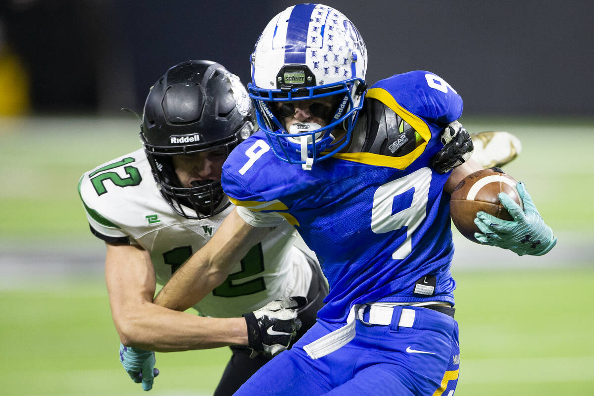 Moapa Valley wide receiver Austin Heiselbetz (9) runs through an attempted tackle by Virgin Val ...