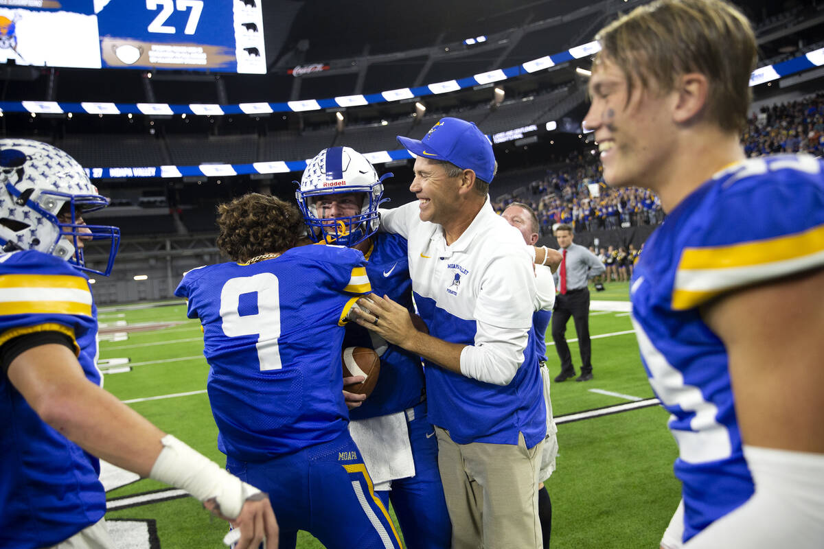 Moapa Valley quarterback Peyton Neilson (1) and wide receiver Austin Heiselbetz (9) hug assista ...
