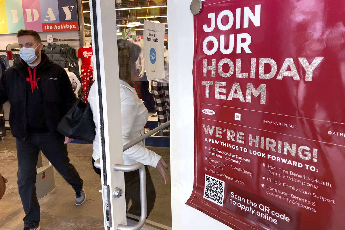 Holiday hiring sign is displayed at a retail store in Vernon Hills, Ill., Saturday, Nov. 13, 20 ...