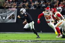 Raiders quarterback Derek Carr (4) scrambles to avoid being sacked as he is pursued by Kansas C ...
