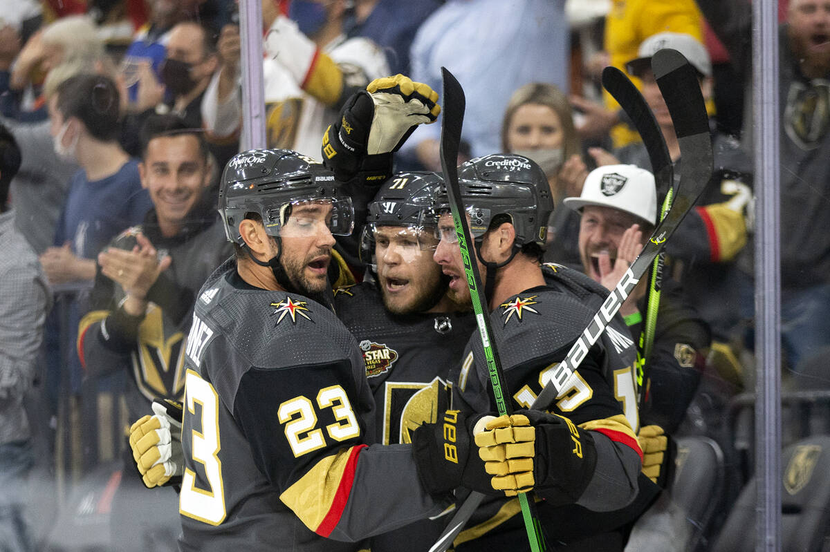 Golden Knights center William Karlsson (71) is congratulated by defenseman Alec Martinez (23) a ...