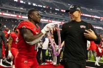 UNLV Rebels running back Charles Williams (8) presents Hawaiian Leis to head coach Marcus Arroy ...