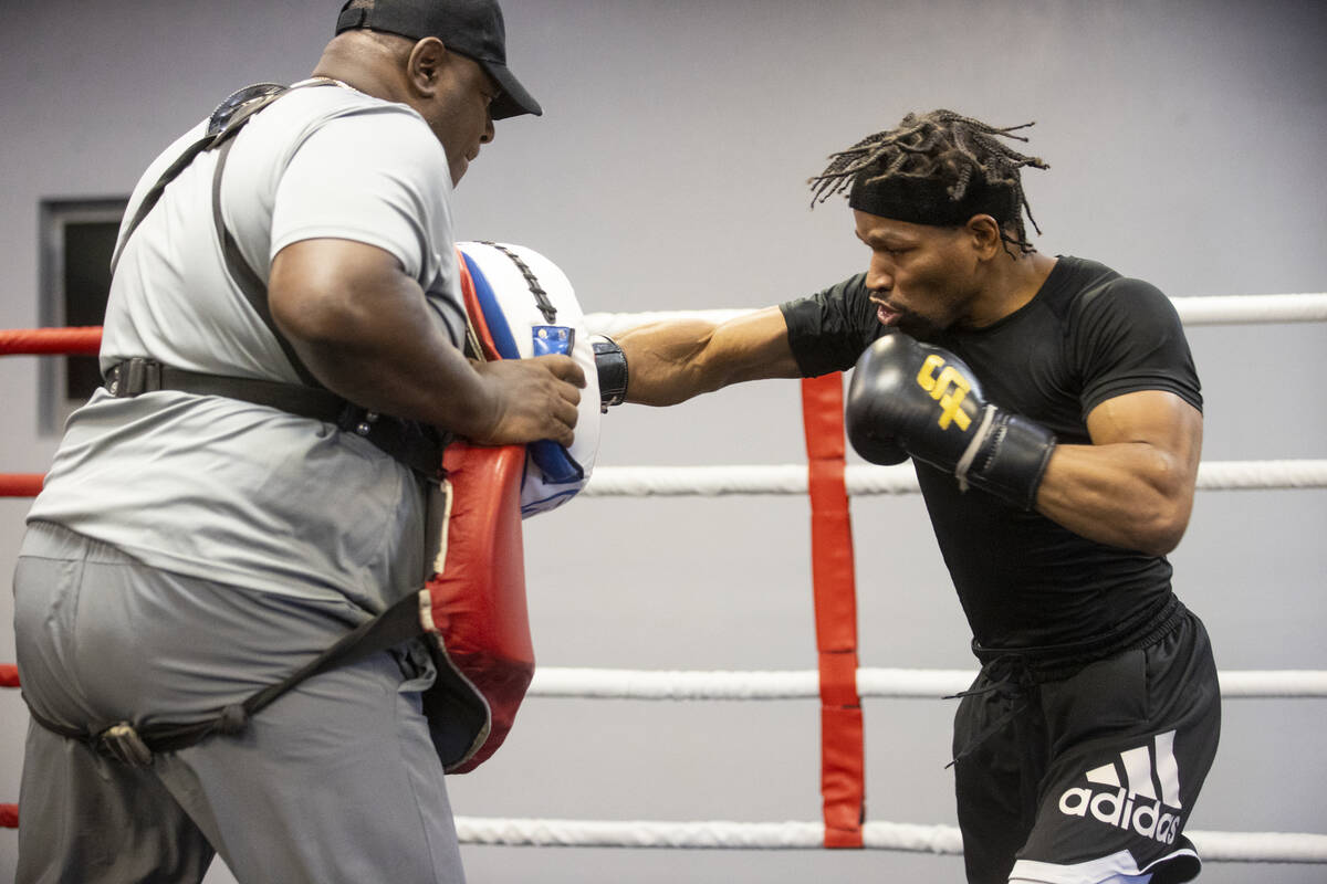 Shawn Porter, right, works on his punches he trainer Rodney Crisler in preparation for an upcom ...