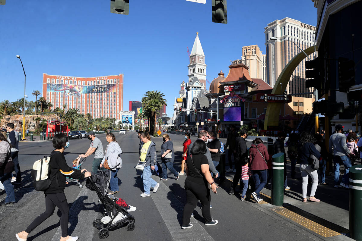 People walk between The Venetian and The Mirage on the Strip in Las Vegas Monday, Nov. 22, 2021 ...