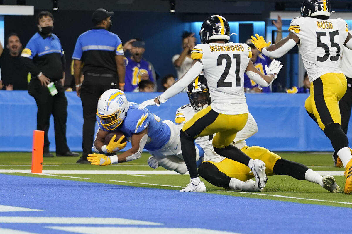 Los Angeles Chargers running back Austin Ekeler scores a touchdown during the second half of an ...