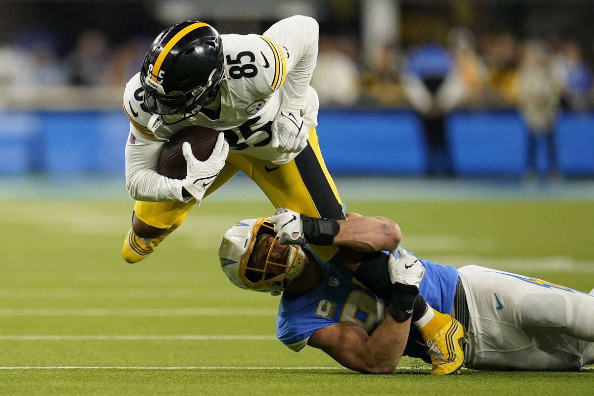 Pittsburgh Steelers tight end Eric Ebron, above, is brought down by Los Angeles Chargers defens ...