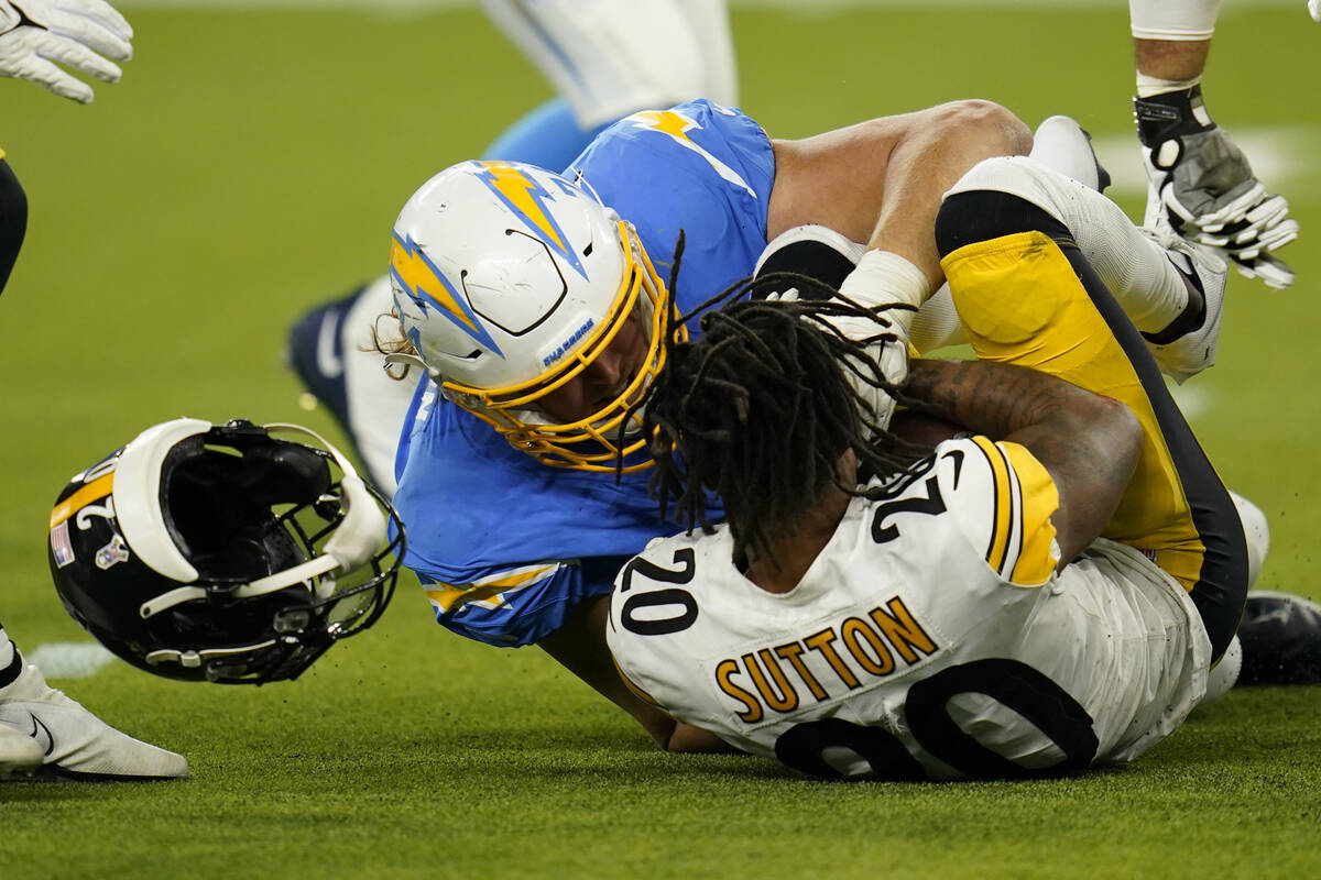 Pittsburgh Steelers cornerback Cameron Sutton, right, is hit by Los Angeles Chargers offensive ...