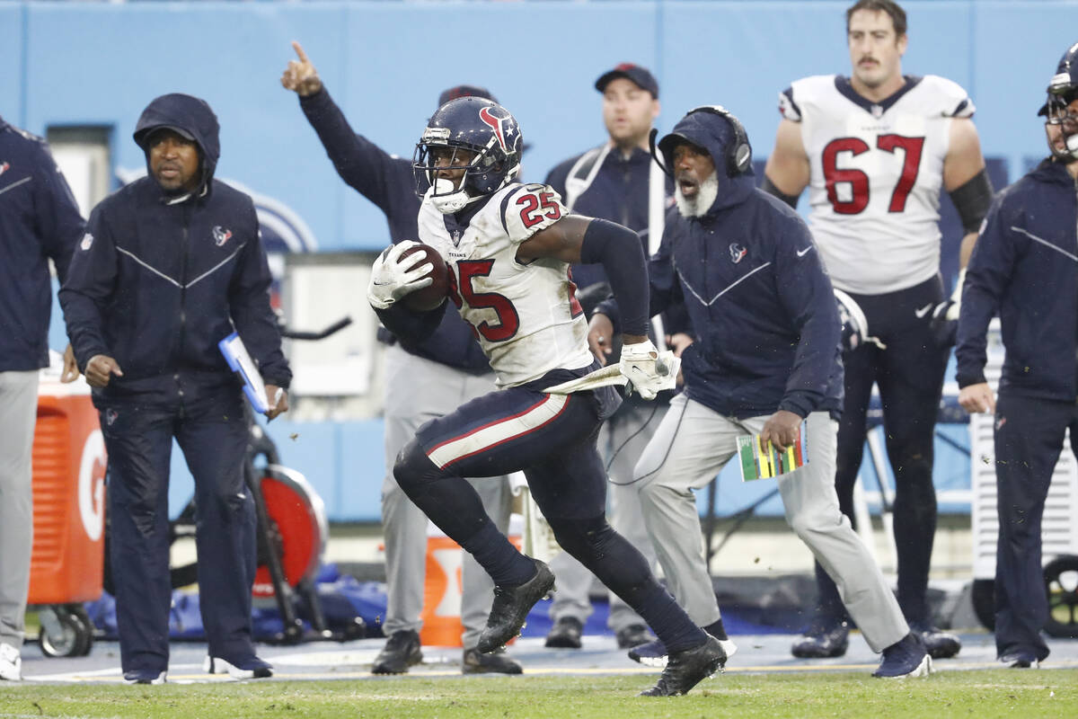 Houston Texans cornerback Desmond King runs back an intercepted pass against the Tennessee Tita ...