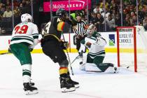 Golden Knights center Paul Cotter, left, scores a goal past Minnesota Wild goaltender Cam Talbo ...