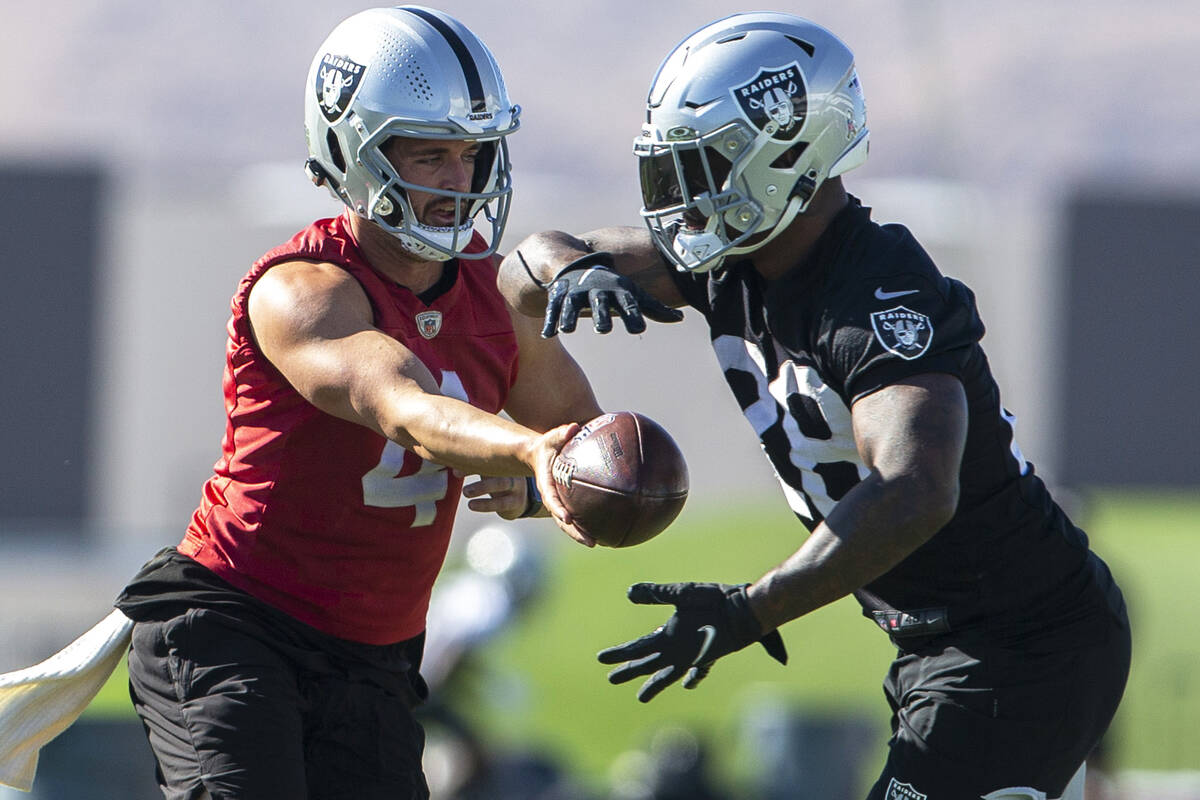 Raiders quarterback Derek Carr (4) hands off the football to Raiders running back Josh Jacobs ( ...