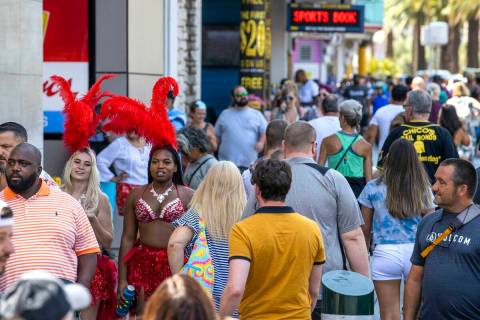 People walk along the Strip near The Venetian on Friday, July 16, 2021, in Las Vegas. (L.E. Bas ...