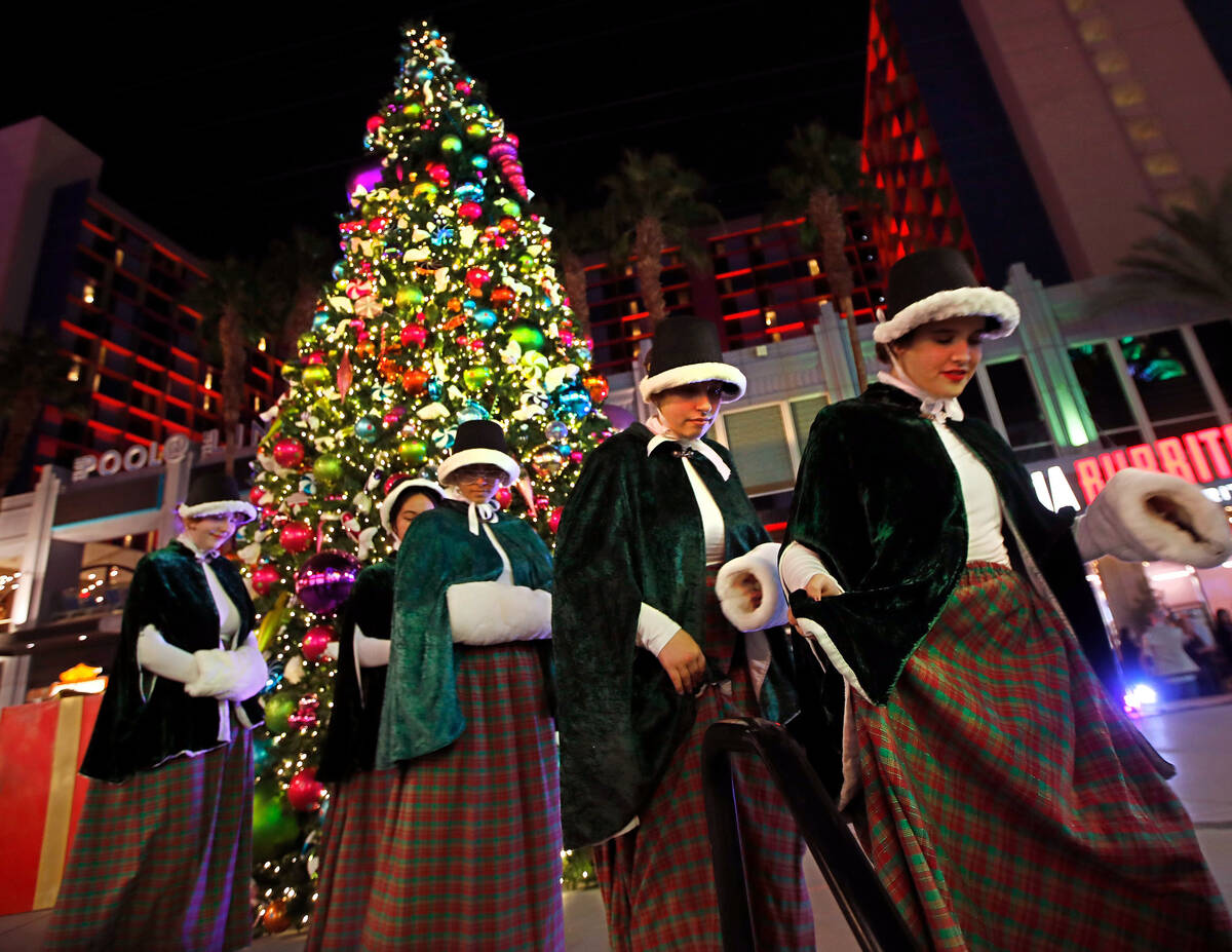 Las Vegas Academy of the Arts Choir members leave after performing during a holiday celebration ...