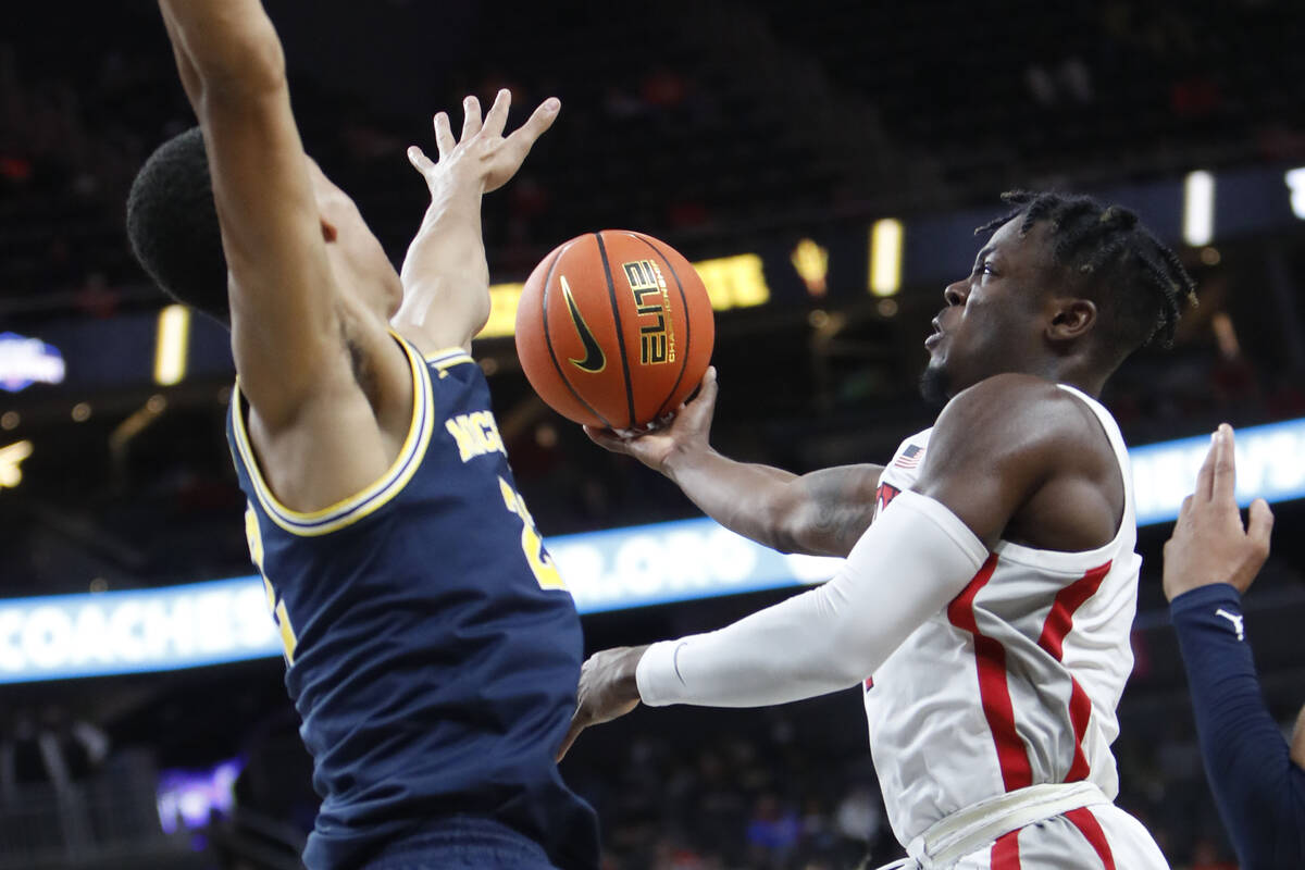 UNLV Rebels guard Michael Nuga (1) shoots over Michigan Wolverines forward Caleb Houstan (22) d ...