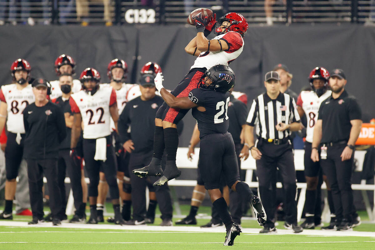 UNLV Rebels defensive back Aaron Lewis (28) tackles San Diego State Aztecs wide receiver Jesse ...