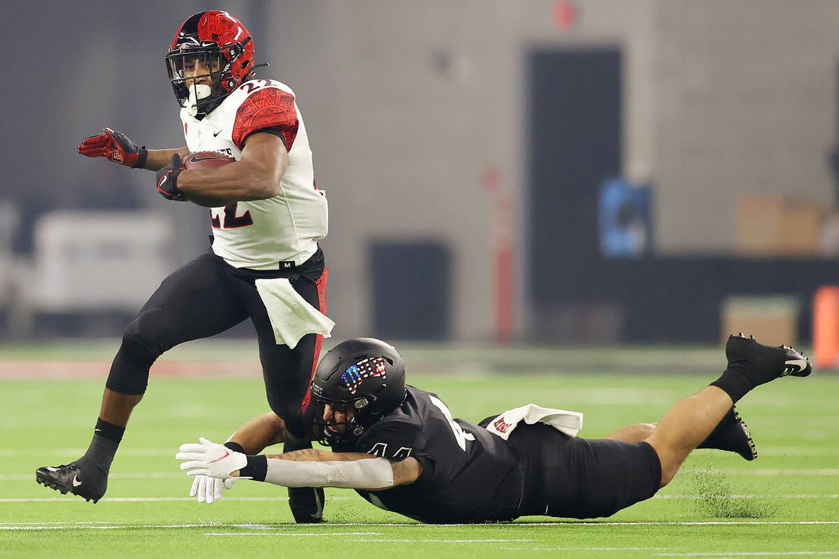 UNLV Rebels linebacker Kyle Beaudry (44) tackles San Diego State Aztecs running back Greg Bell ...