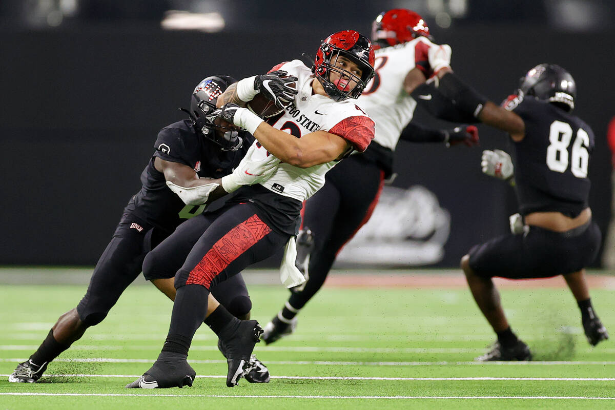 San Diego State Aztecs linebacker Seyddrick Lakalaka (43) spins while getting tackled by UNLV R ...