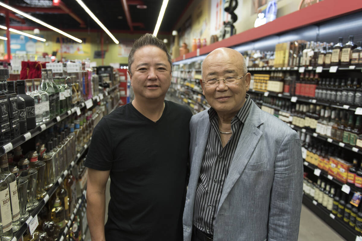 Hae Un Lee, founder of Lee's Discount Liquor, right, and his son, Kenny Lee, stand in an aisle ...