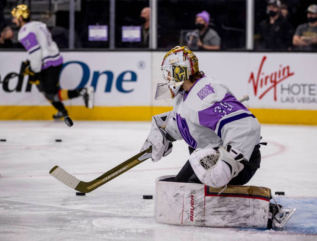 Golden Knights goaltender Laurent Brossoit (39) warms up before the first period of an NHL game ...
