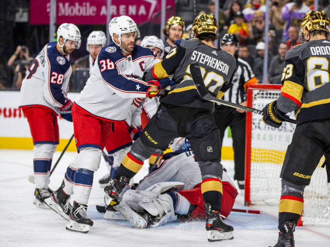 Columbus Blue Jackets center Boone Jenner (38) and Golden Knights center Chandler Stephenson (2 ...