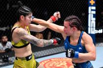 (R-L) Miesha Tate punches Ketlen Vieira of Brazil in a bantamweight fight during the UFC Fight ...