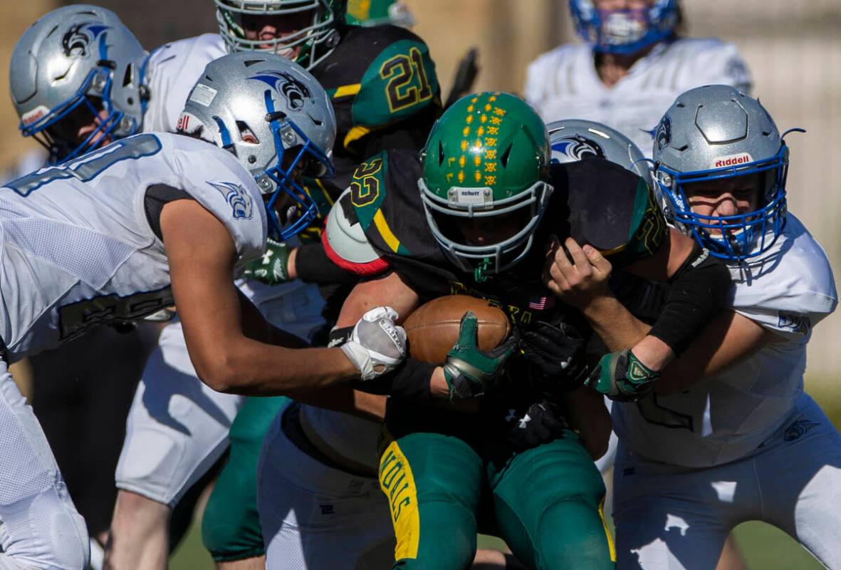 Eureka’s Danny Lee (22) is stacked up by Pahranagat Valley defenders in the first half d ...