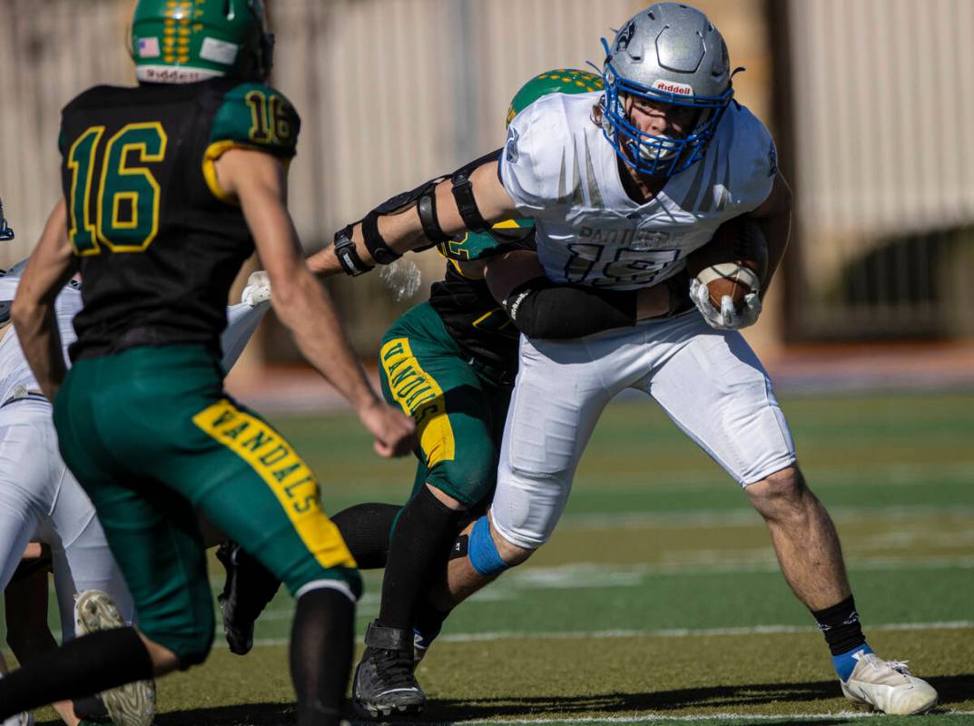 Pahranagat Valley’s Paul Lewis fights for extra yardage against Eureka’s Danny Le ...