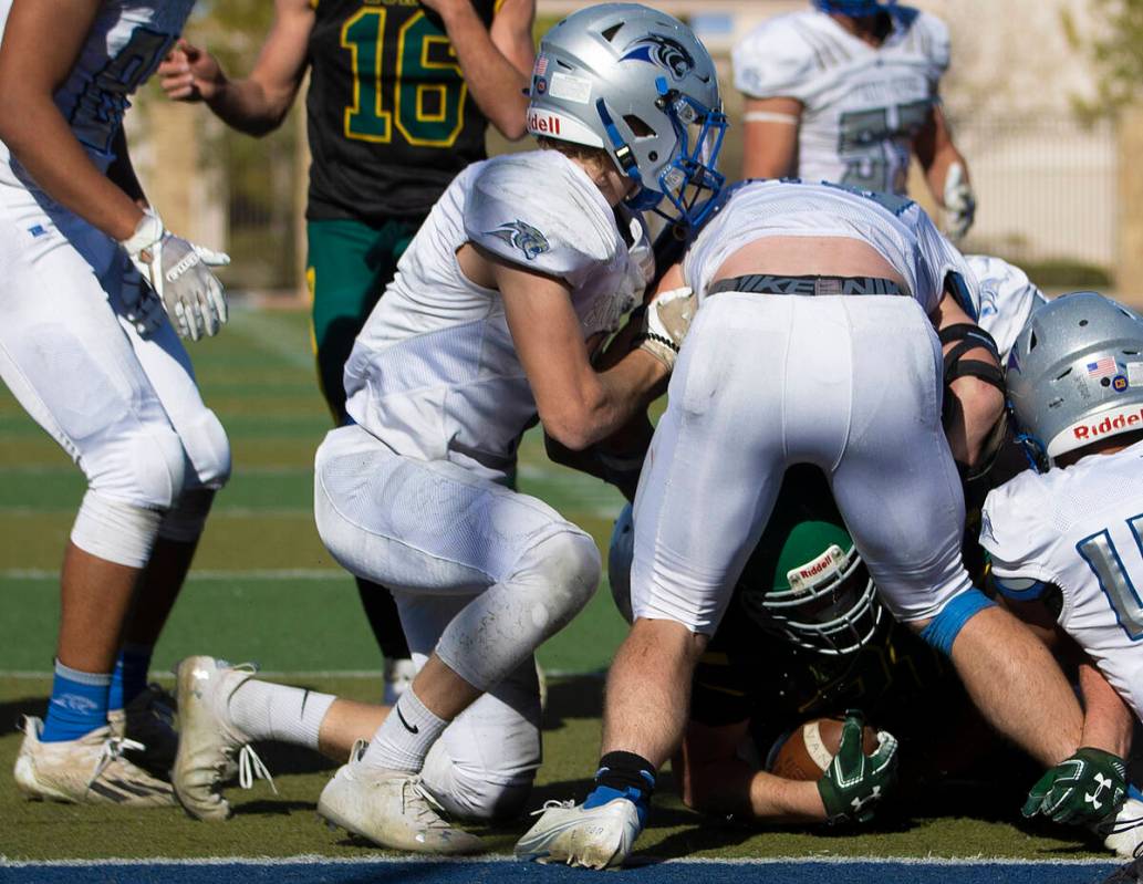 Eureka’s Danny Lee (22) is bottled up near the end zone by Pahranagat Valley defenders i ...
