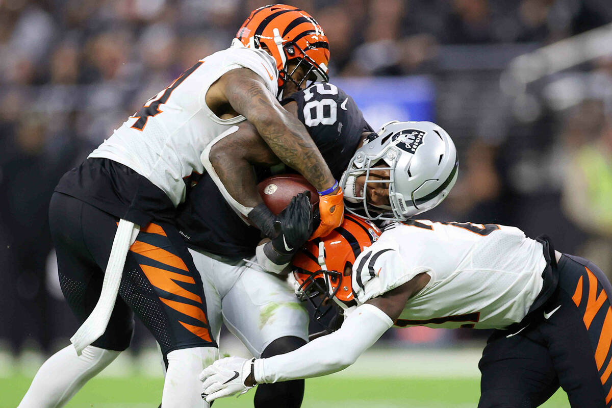 Cincinnati Bengals safety Vonn Bell (24) and cornerback Mike Hilton (21) tackle Raiders running ...