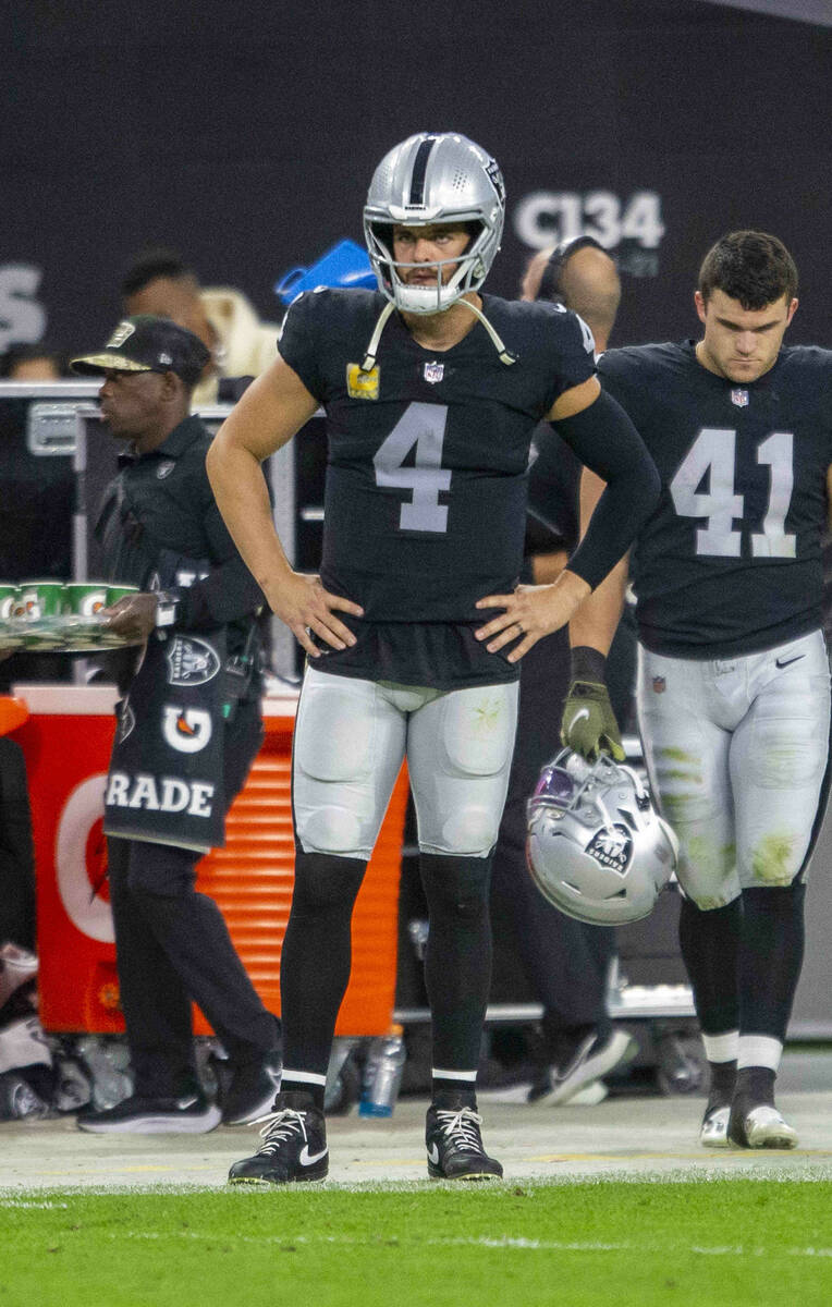 Raiders quarterback Derek Carr (4) looks on from the sideline after throwing an interception du ...